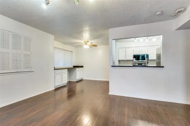 a view of a kitchen with a sink and cabinet with wooden floor
