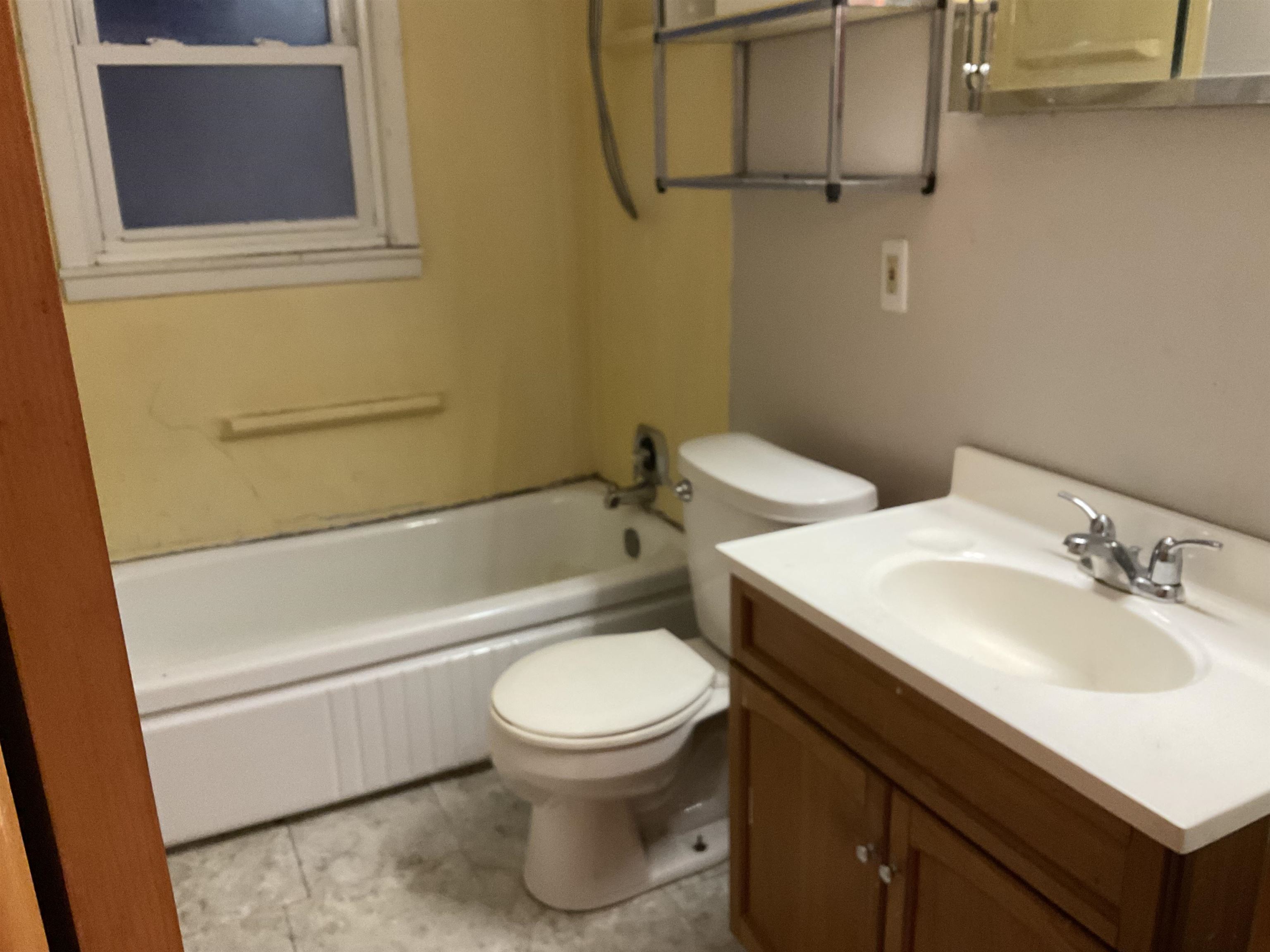7004 Will James Road Rockford, IL 61109 - Photo 11 of 13 a bathroom with a sink a toilet and a bathtub