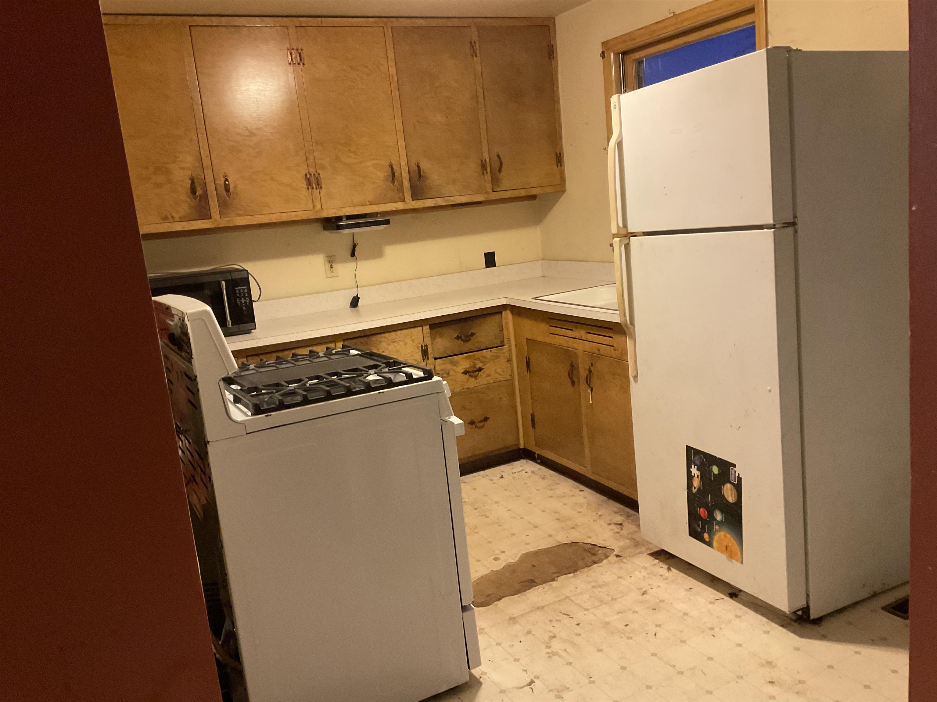 7004 Will James Road Rockford, IL 61109 - Photo 8 of 13 a kitchen with a refrigerator and a stove
