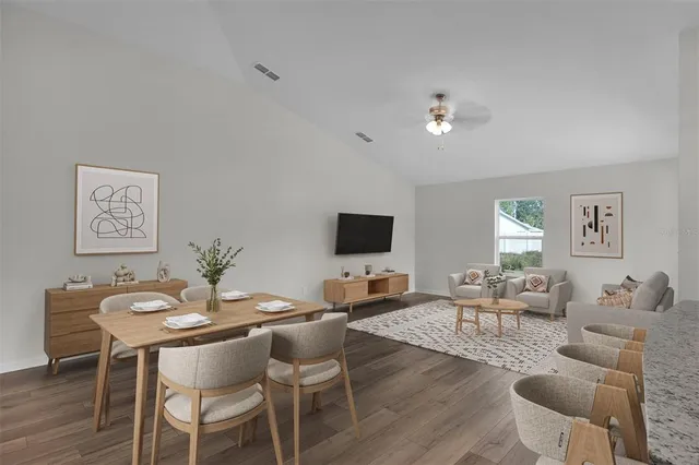 a living room with furniture a window and a flat screen tv