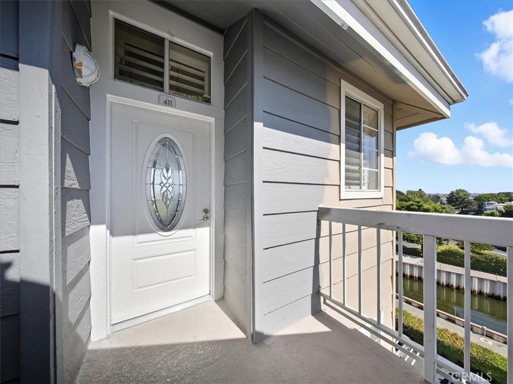 20331 Bluffside Circle, Unit A411 Huntington Beach, CA 92646 - Photo 14 of 44 Enter through a beautifully leaded glass front door—this decorative feature balances privacy and natural light, elevating your entryway’s style.