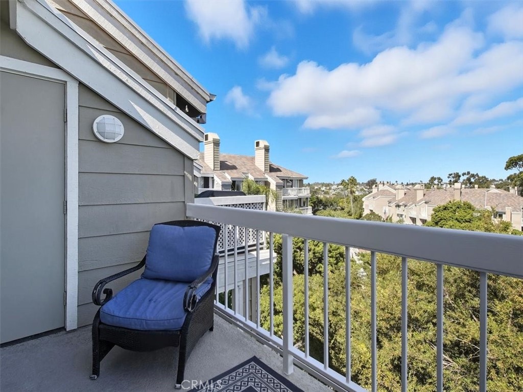 20331 Bluffside Circle, Unit A411 Huntington Beach, CA 92646 - Photo 20 of 44 West-facing penthouse balcony offering sweeping views of Huntington Beach, capturing the vibrant energy of the coast.