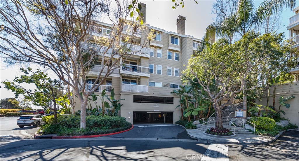 20331 Bluffside Circle, Unit A411 Huntington Beach, CA 92646 - Photo 40 of 44 a front view of a building with garden