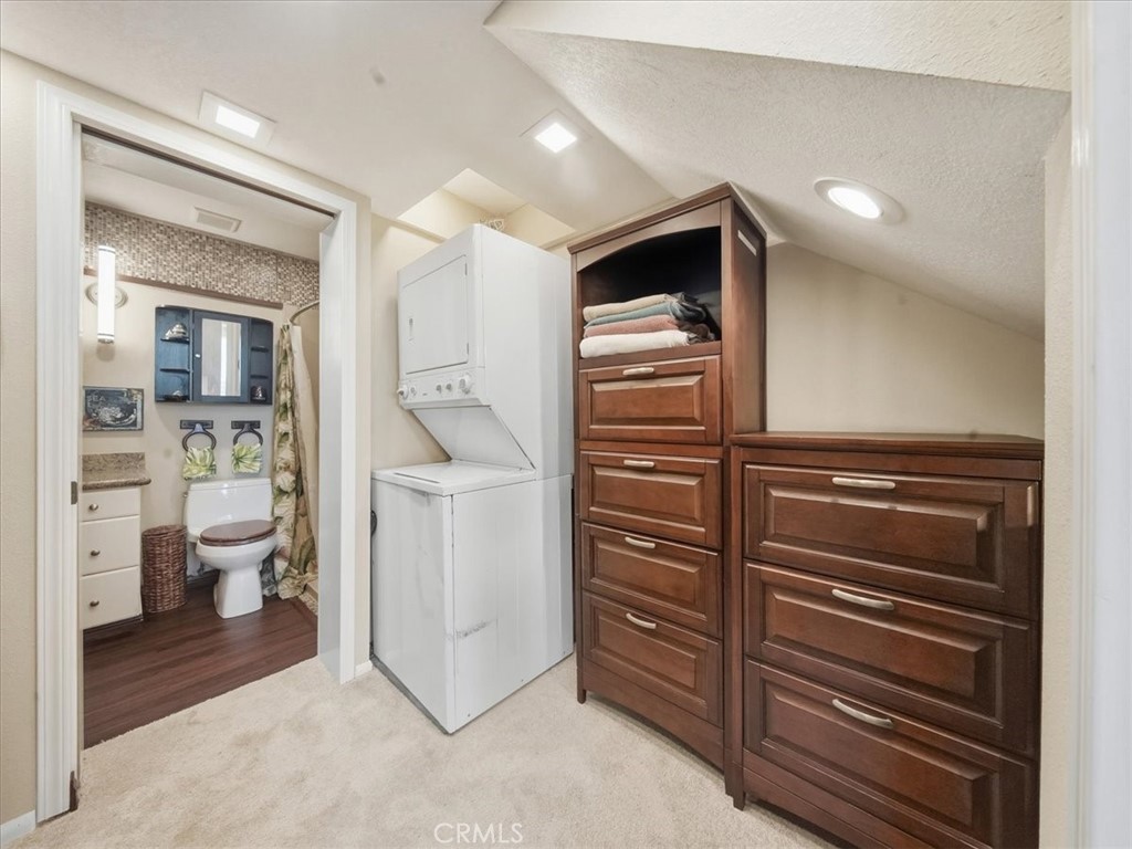 20331 Bluffside Circle, Unit A411 Huntington Beach, CA 92646 - Photo 10 of 44 a kitchen with a refrigerator and an oven