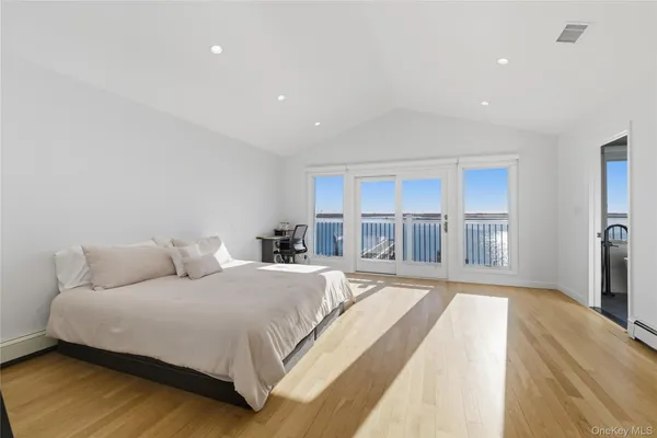 a spacious bedroom with a large bed and a large window