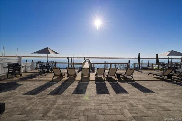 a view of a patio with table and chairs under an umbrella