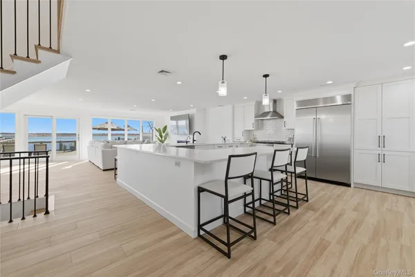 a kitchen with stainless steel appliances kitchen island hardwood floor and a counter top space