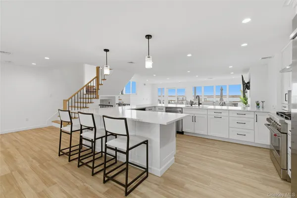 a kitchen with a table chairs sink and cabinets