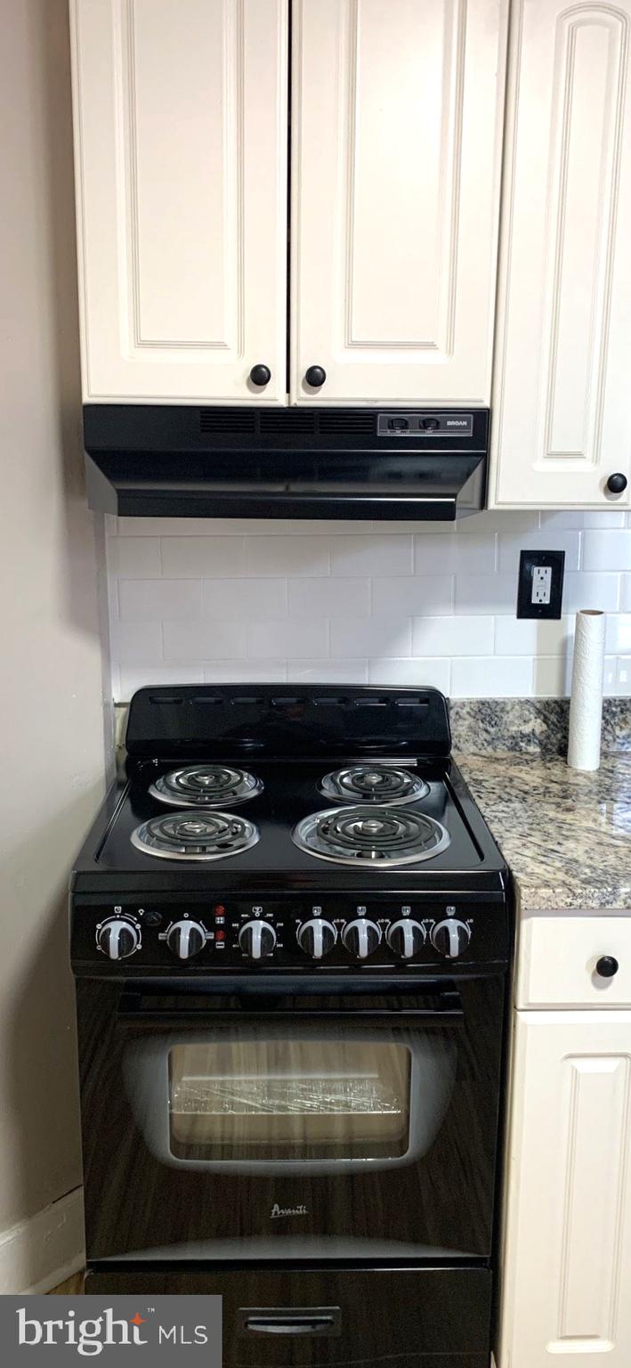252 Rosemar Street, Unit 2 Philadelphia, PA 19120 - Photo 11 of 22 a stove top oven sitting inside of a kitchen