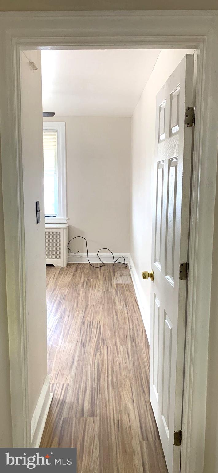 252 Rosemar Street, Unit 2 Philadelphia, PA 19120 - Photo 15 of 22 a view of a bedroom with wooden floor and front door
