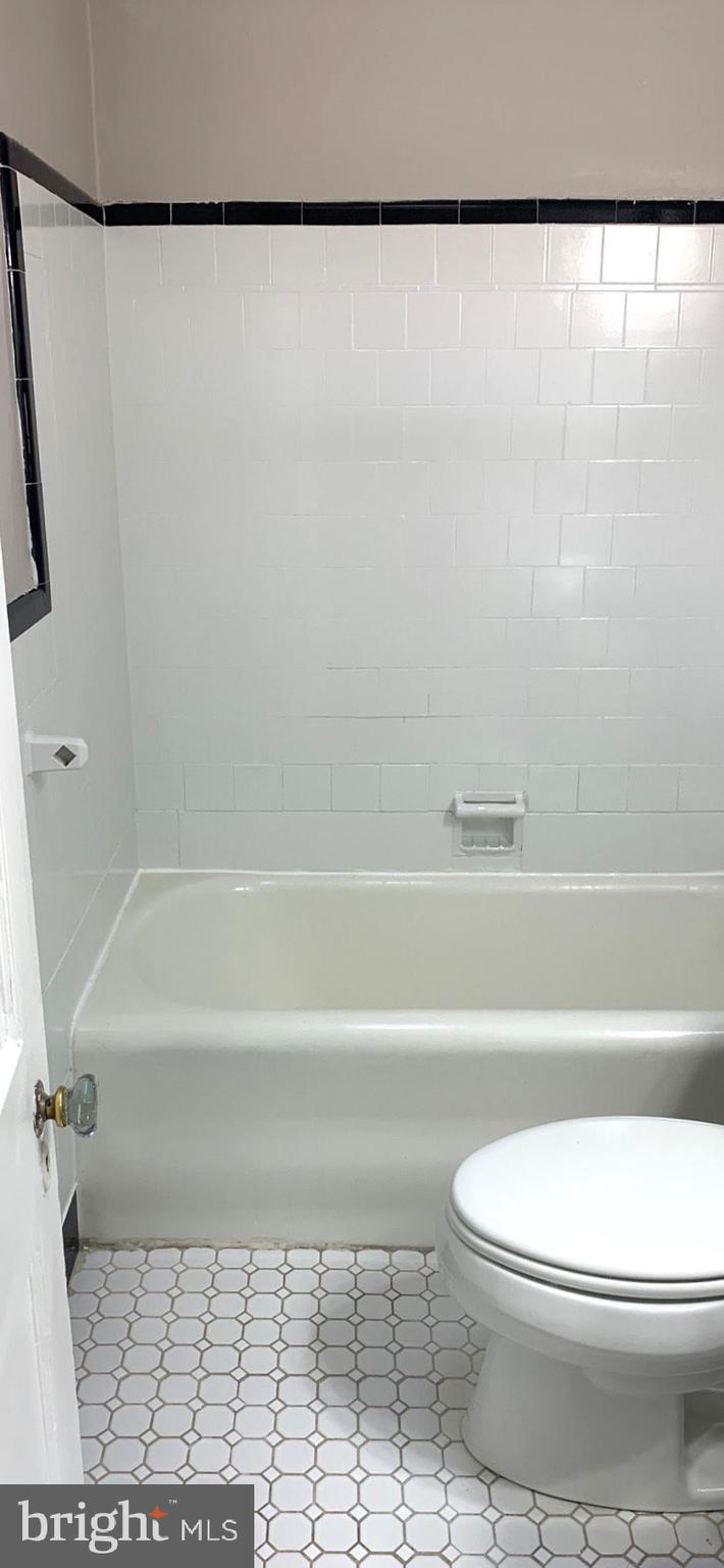 252 Rosemar Street, Unit 2 Philadelphia, PA 19120 - Photo 22 of 22 a bathroom with a toilet and a bathtub