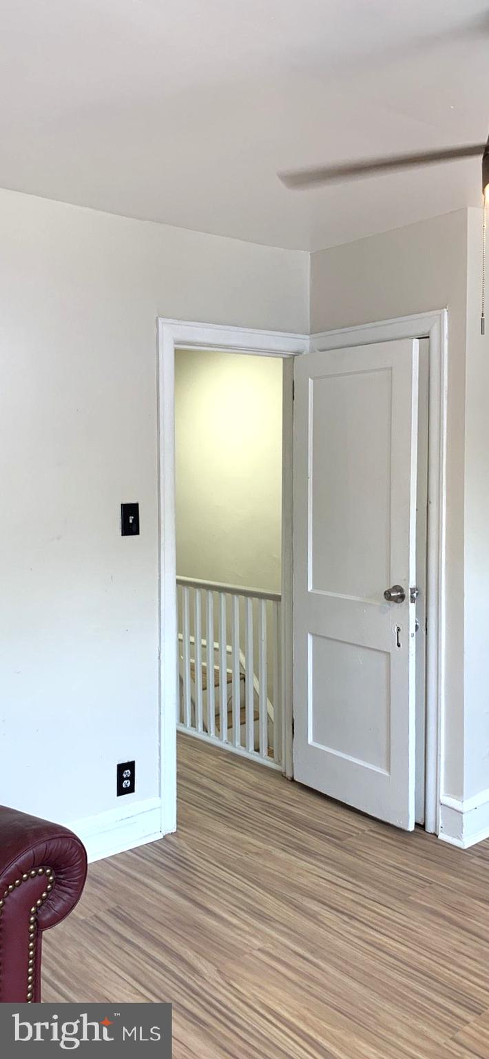 252 Rosemar Street, Unit 2 Philadelphia, PA 19120 - Photo 8 of 22 a view of a hallway with wooden floor and a bathroom