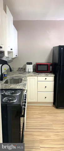 a kitchen with stainless steel appliances granite countertop a stove and a refrigerator