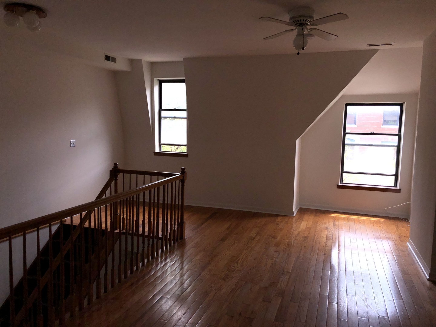 Undisclosed Address Chicago, IL 60607 - Photo 6 of 8 an empty room with wooden floor fan and windows