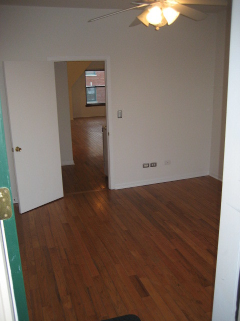 Undisclosed Address Chicago, IL 60607 - Photo 7 of 8 an empty room with wooden floor and closet