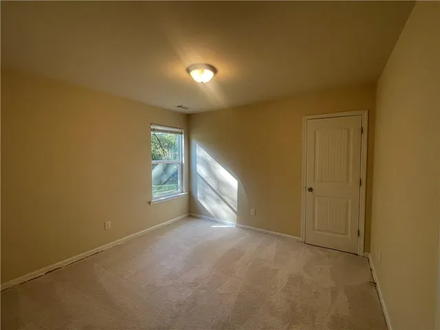 a view of an empty room and a window