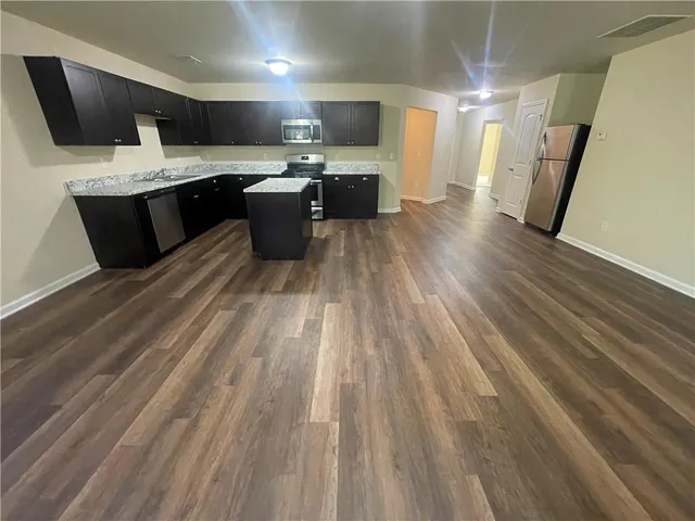 a kitchen with a sink and a stove top oven
