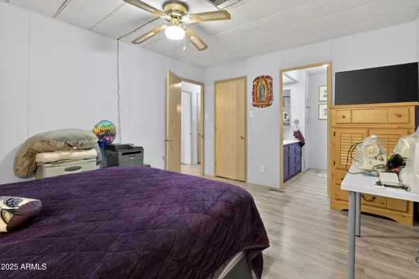 a bedroom with a bed and wooden floor