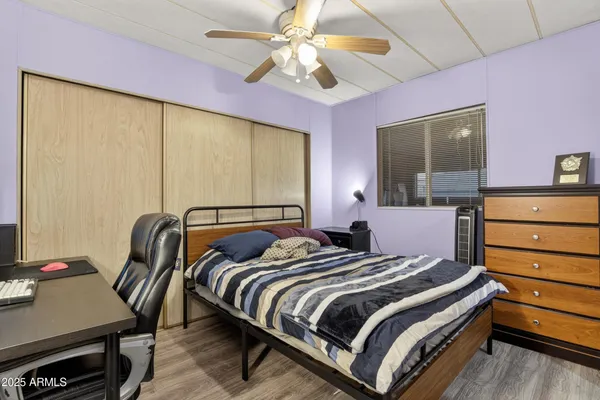 a bedroom with a bed and a desk