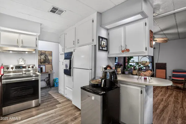 a kitchen with refrigerator and stove