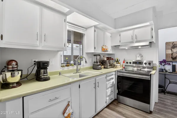 a kitchen with cabinets and stainless steel appliances