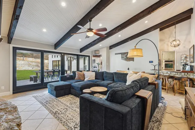 a living room with furniture ceiling fan and a rug