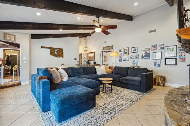 a living room with furniture and a chandelier