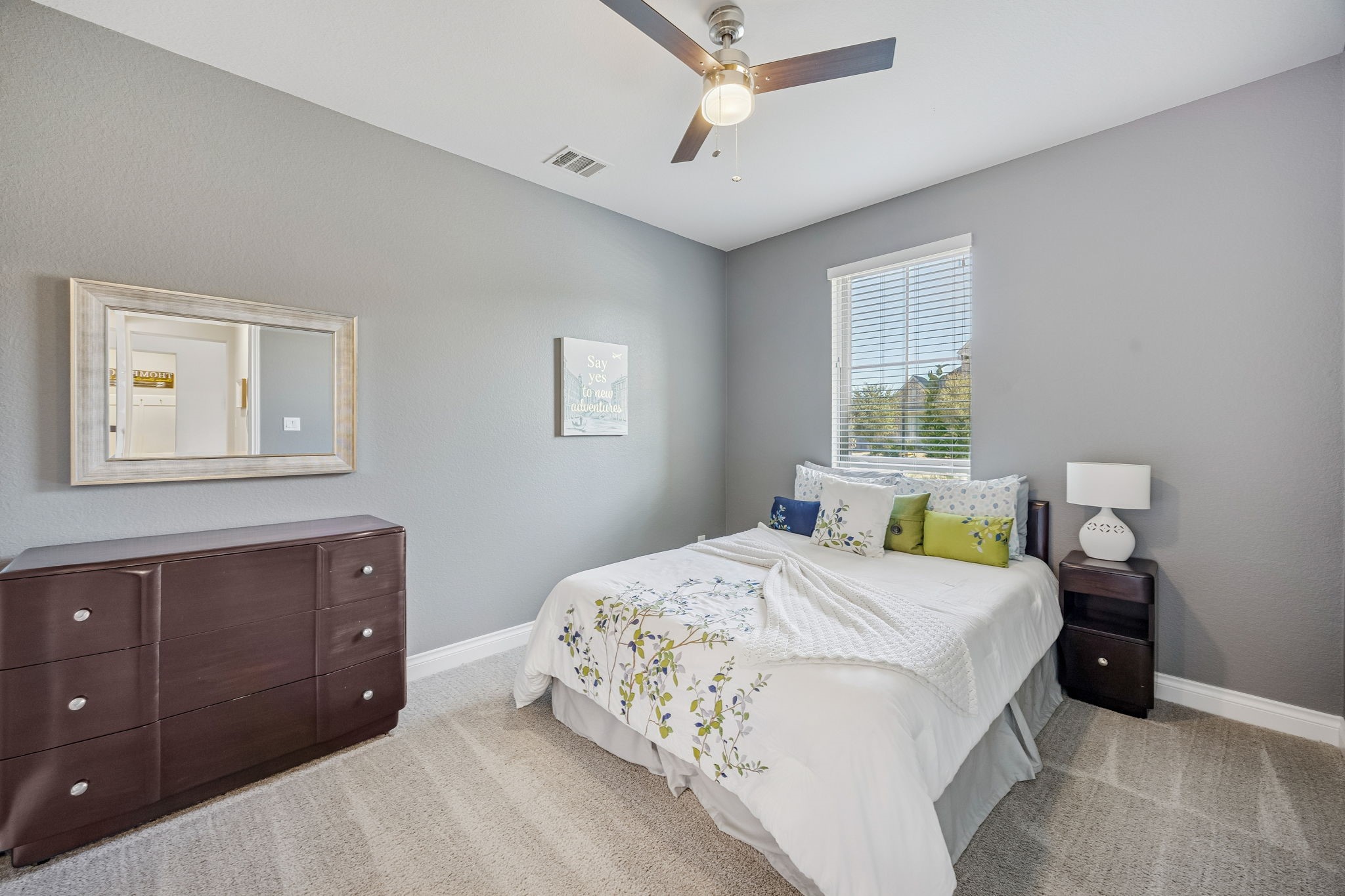 28706 Casen Ranch Lane Fulshear, TX 77441 - Photo 16 of 31 This versatile secondary bedroom is conveniently located on the first floor, offering plush carpet and neutral finishes. Large windows and a modern ceiling fan make this an ideal space for guests.
