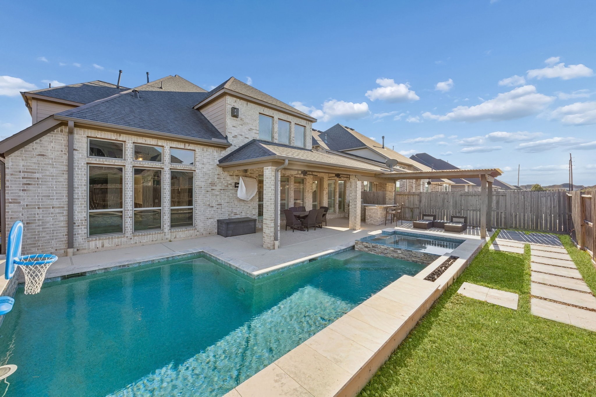 28706 Casen Ranch Lane Fulshear, TX 77441 - Photo 2 of 31 Step into a private paradise featuring a sparkling heated gunite pool and integrated spa. Managed by smartphone controls, the pool area includes elegant water features for year-round outdoor enjoyment.