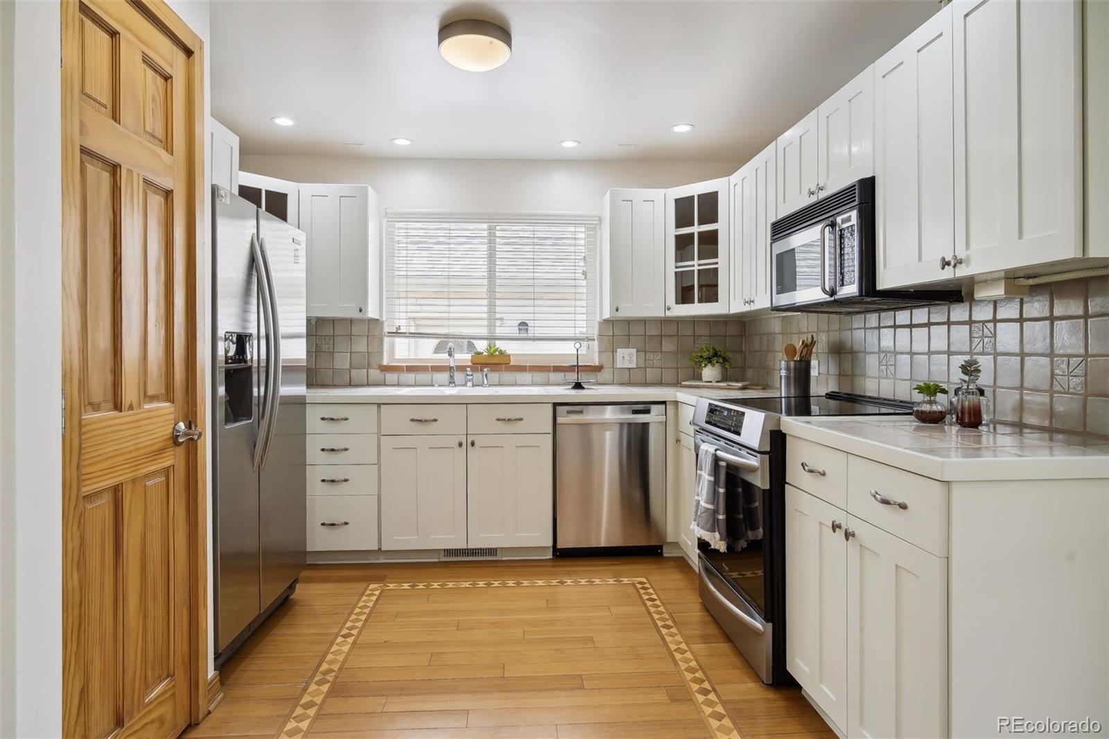 2675 Raleigh Street Denver, CO 80212 - Photo 12 of 33 a kitchen with a sink stove and refrigerator