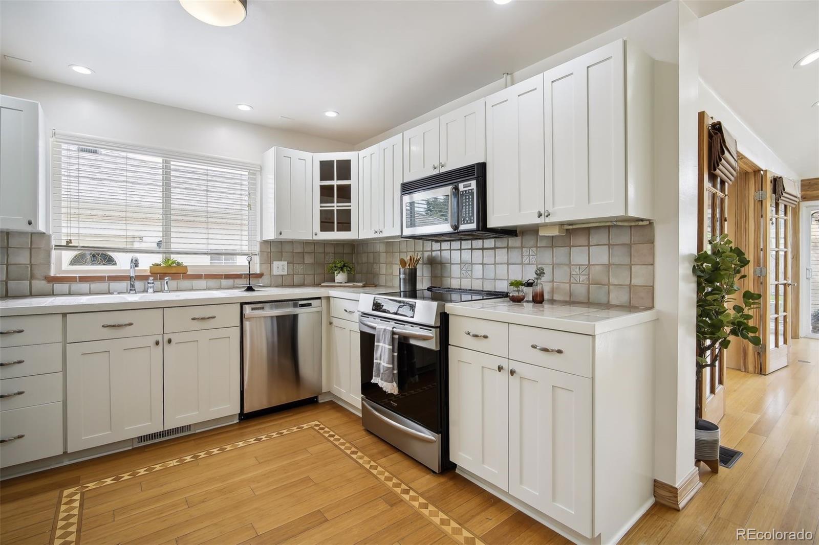 2675 Raleigh Street Denver, CO 80212 - Photo 13 of 33 a kitchen with white cabinets sink and appliances