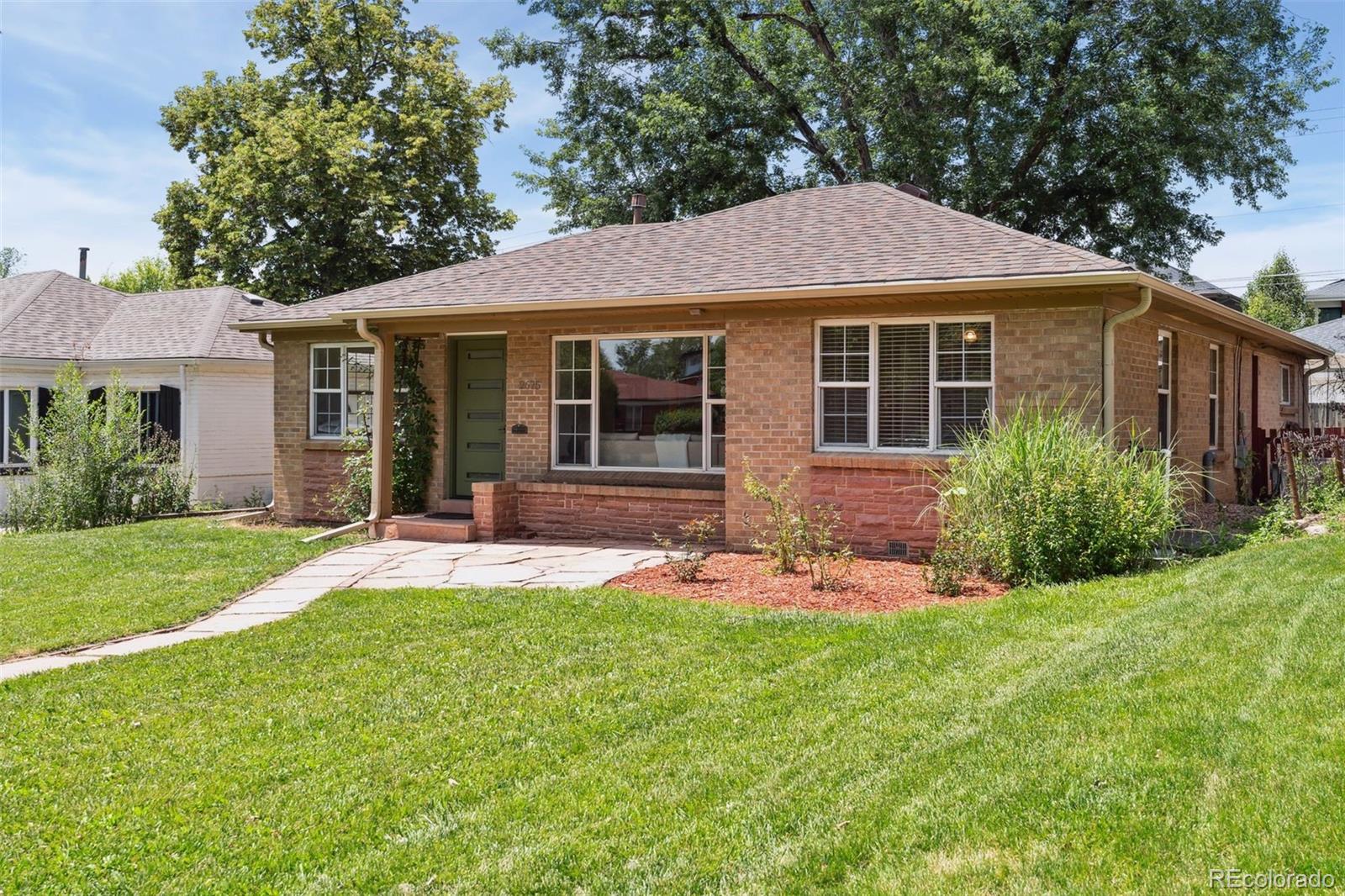 2675 Raleigh Street Denver, CO 80212 - Photo 2 of 33 a front view of a house with a yard and porch