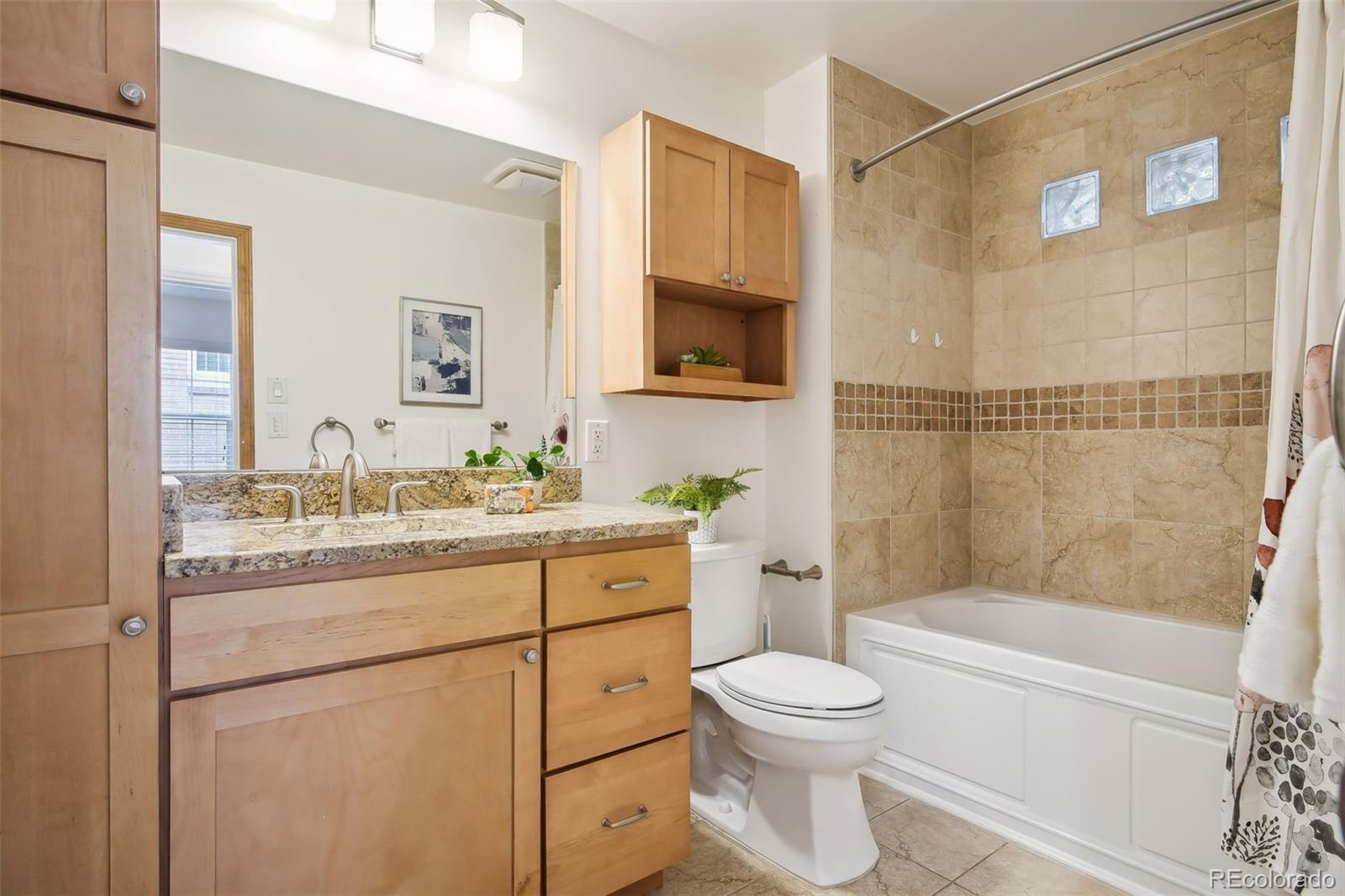 2675 Raleigh Street Denver, CO 80212 - Photo 21 of 33 a bathroom with a granite countertop toilet sink and a bathtub
