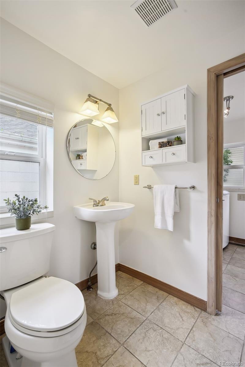 2675 Raleigh Street Denver, CO 80212 - Photo 25 of 33 a bathroom with a sink toilet and mirror
