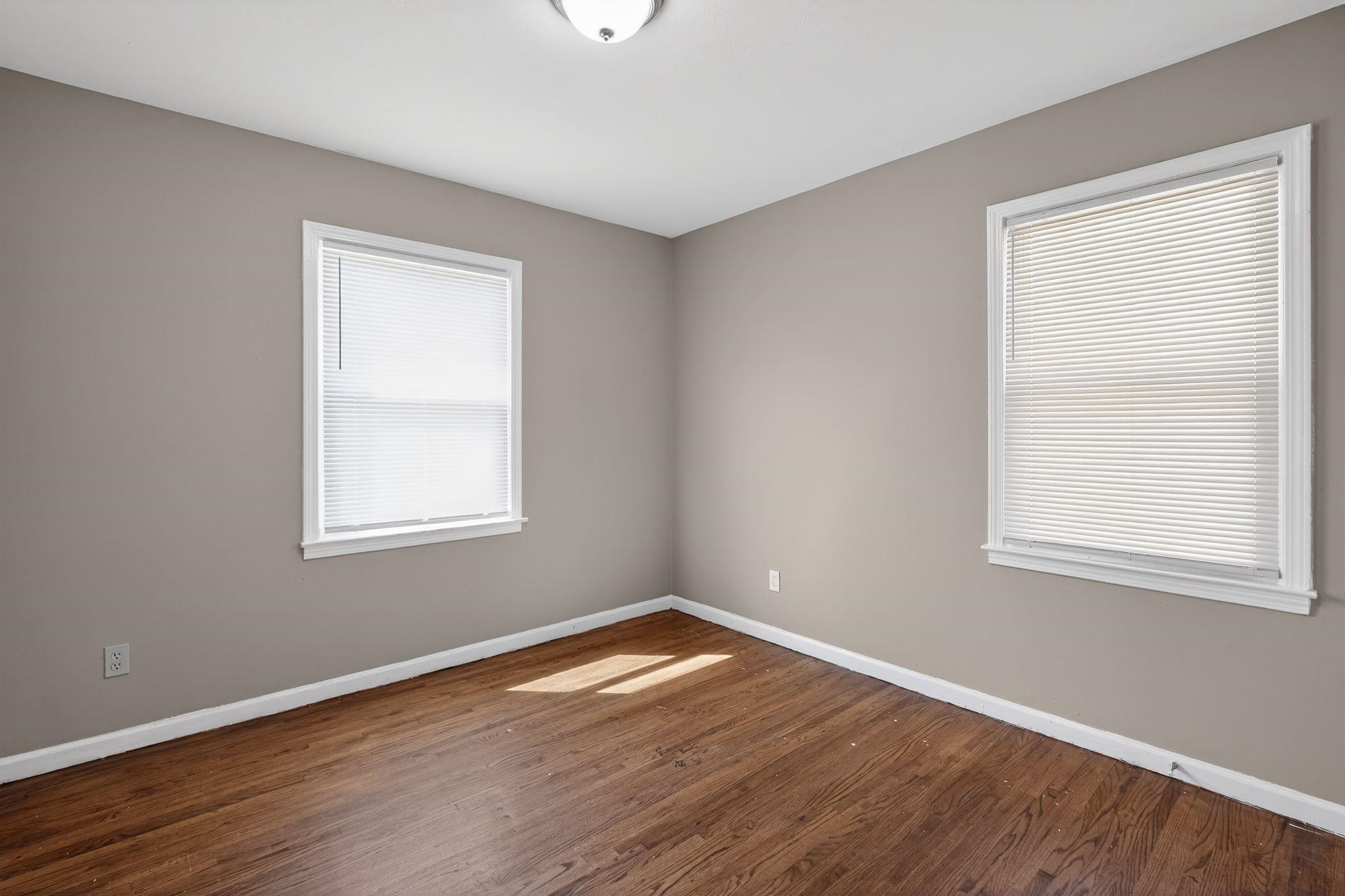 3220 Christine Road Memphis, TN 38118 - Photo 11 of 35 an empty room with wooden floor and windows