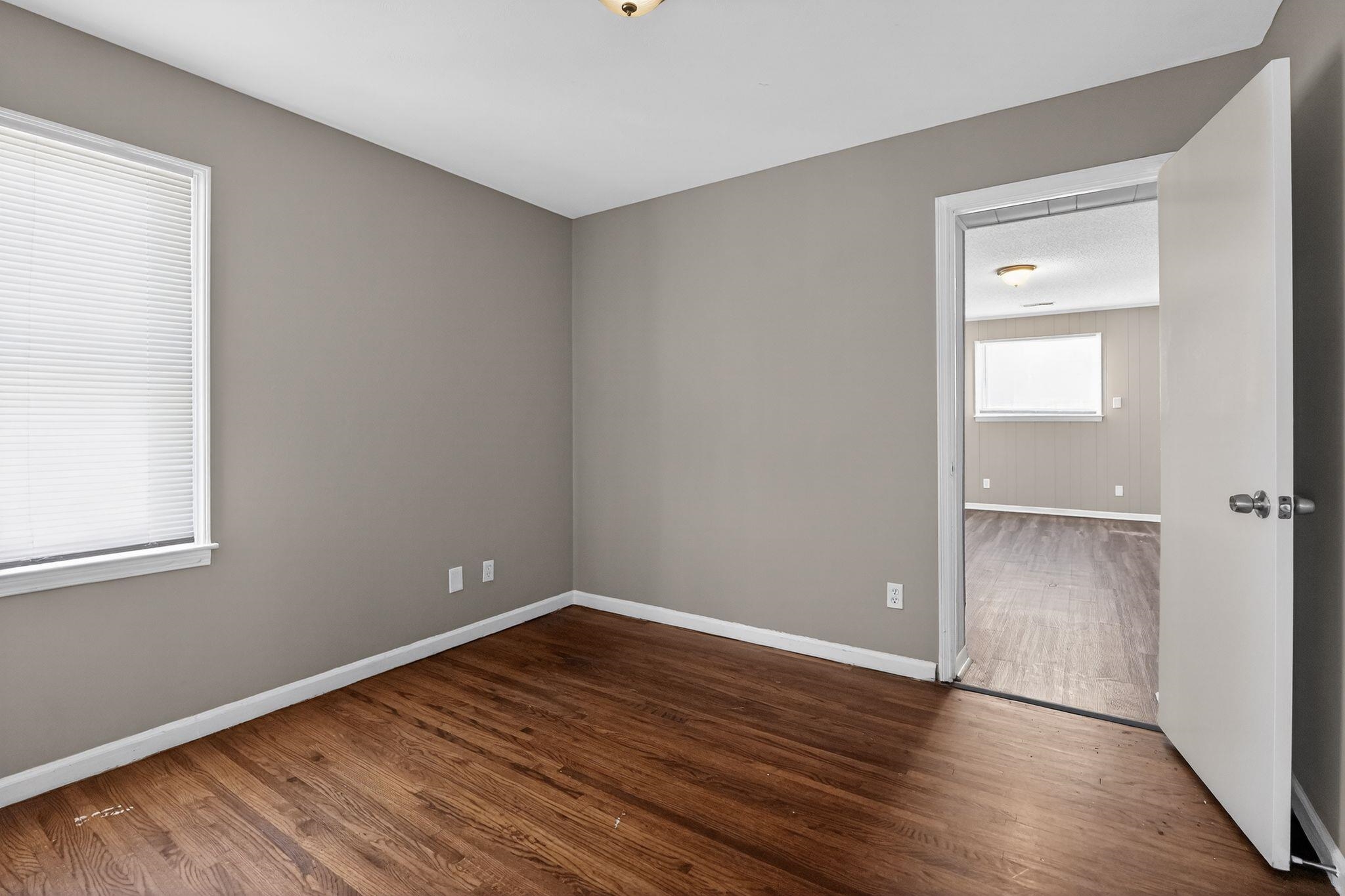 3220 Christine Road Memphis, TN 38118 - Photo 16 of 35 a view of an empty room with wooden floor and a window