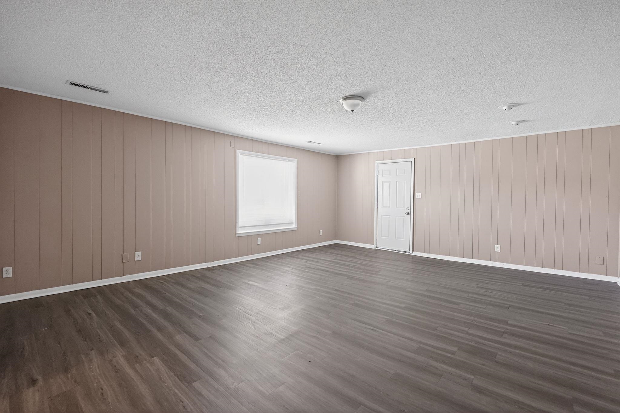 3220 Christine Road Memphis, TN 38118 - Photo 17 of 35 a view of an empty room with wooden floor and window