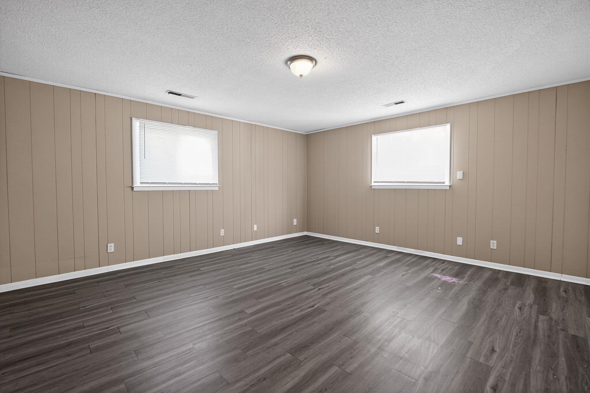 3220 Christine Road Memphis, TN 38118 - Photo 18 of 35 a view of an empty room with wooden floor and a window