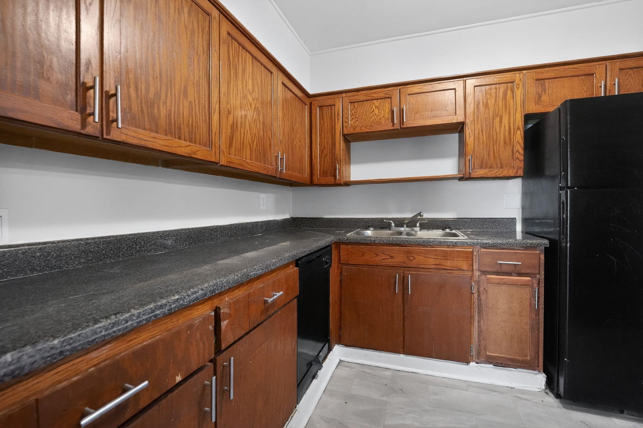 3220 Christine Road Memphis, TN 38118 - Photo 25 of 35 a kitchen with granite countertop cabinets and refrigerator