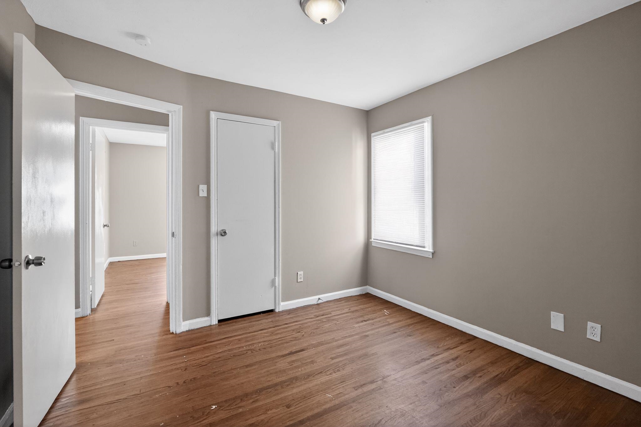 3220 Christine Road Memphis, TN 38118 - Photo 26 of 35 a view of an empty room with wooden floor and a window