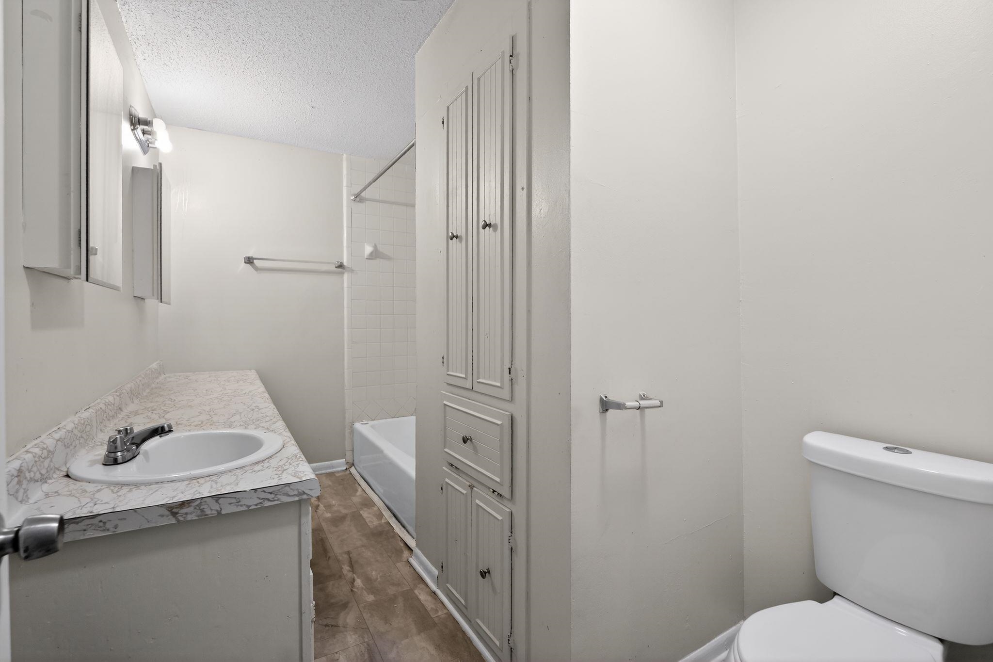 3220 Christine Road Memphis, TN 38118 - Photo 28 of 35 a bathroom with a granite countertop sink toilet and shower
