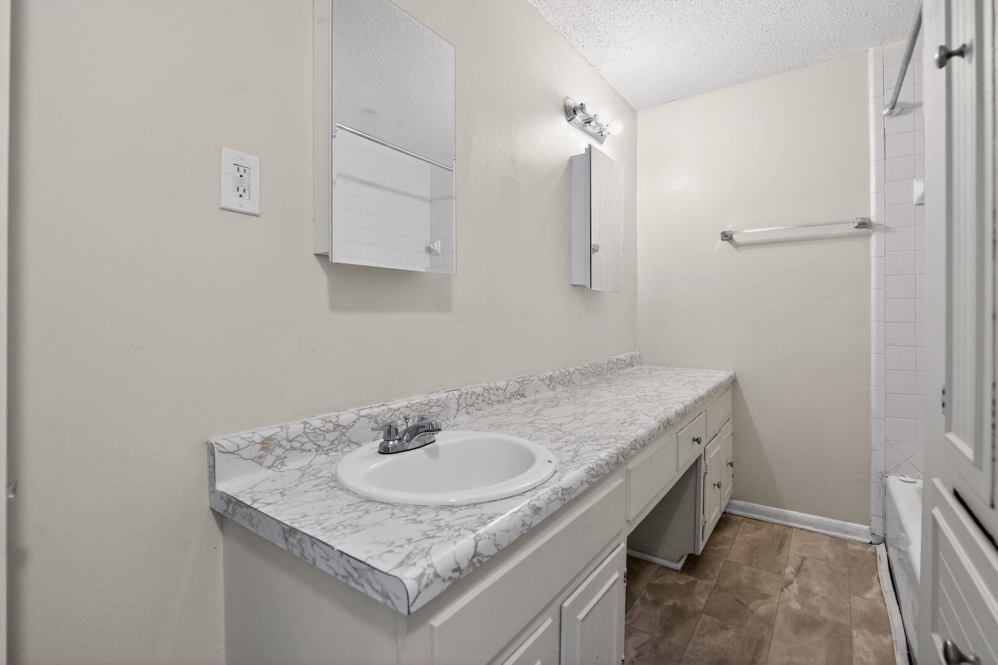 3220 Christine Road Memphis, TN 38118 - Photo 29 of 35 a bathroom with a granite countertop sink and a mirror