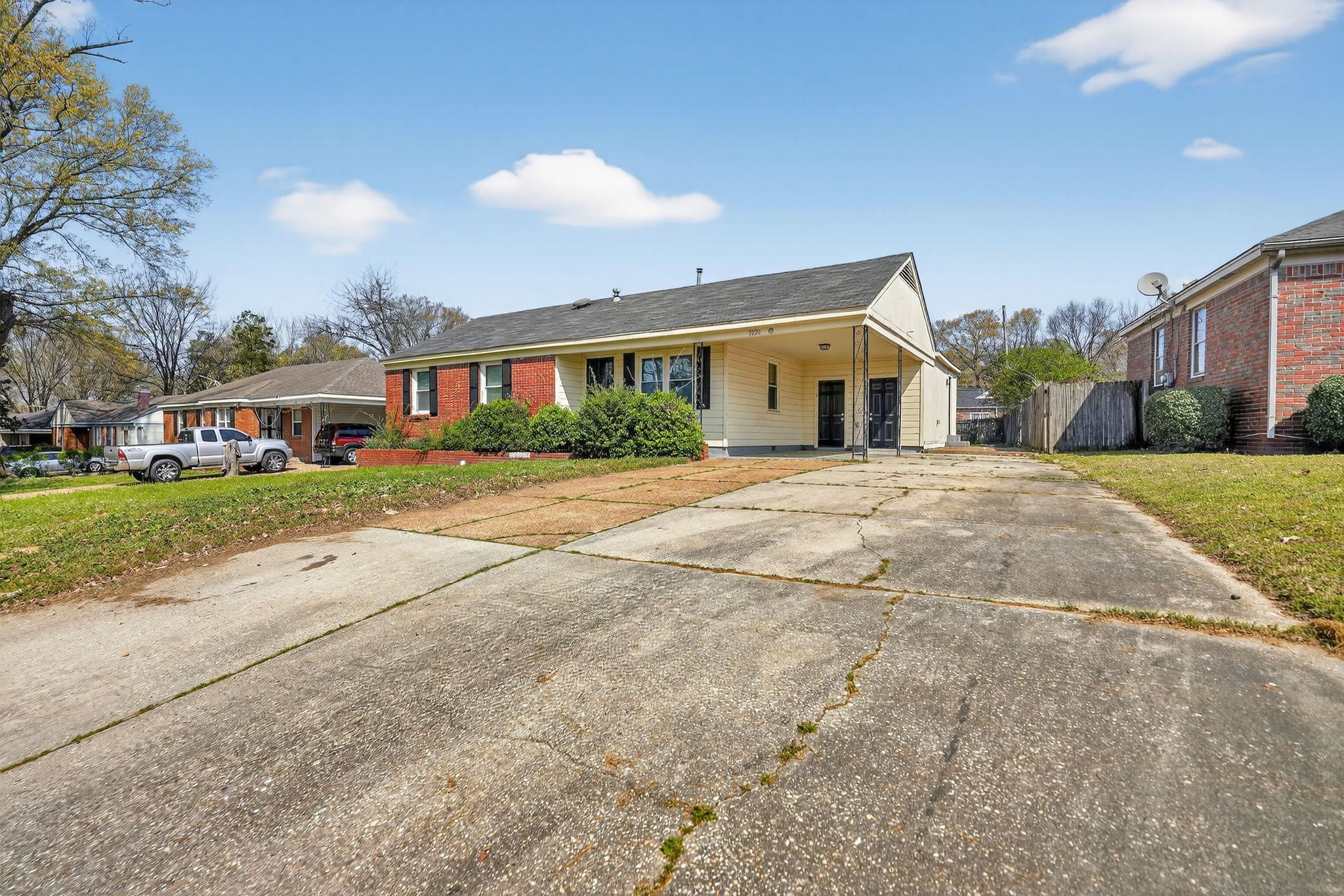 3220 Christine Road Memphis, TN 38118 - Photo 3 of 35 a front view of a house with a yard and garage