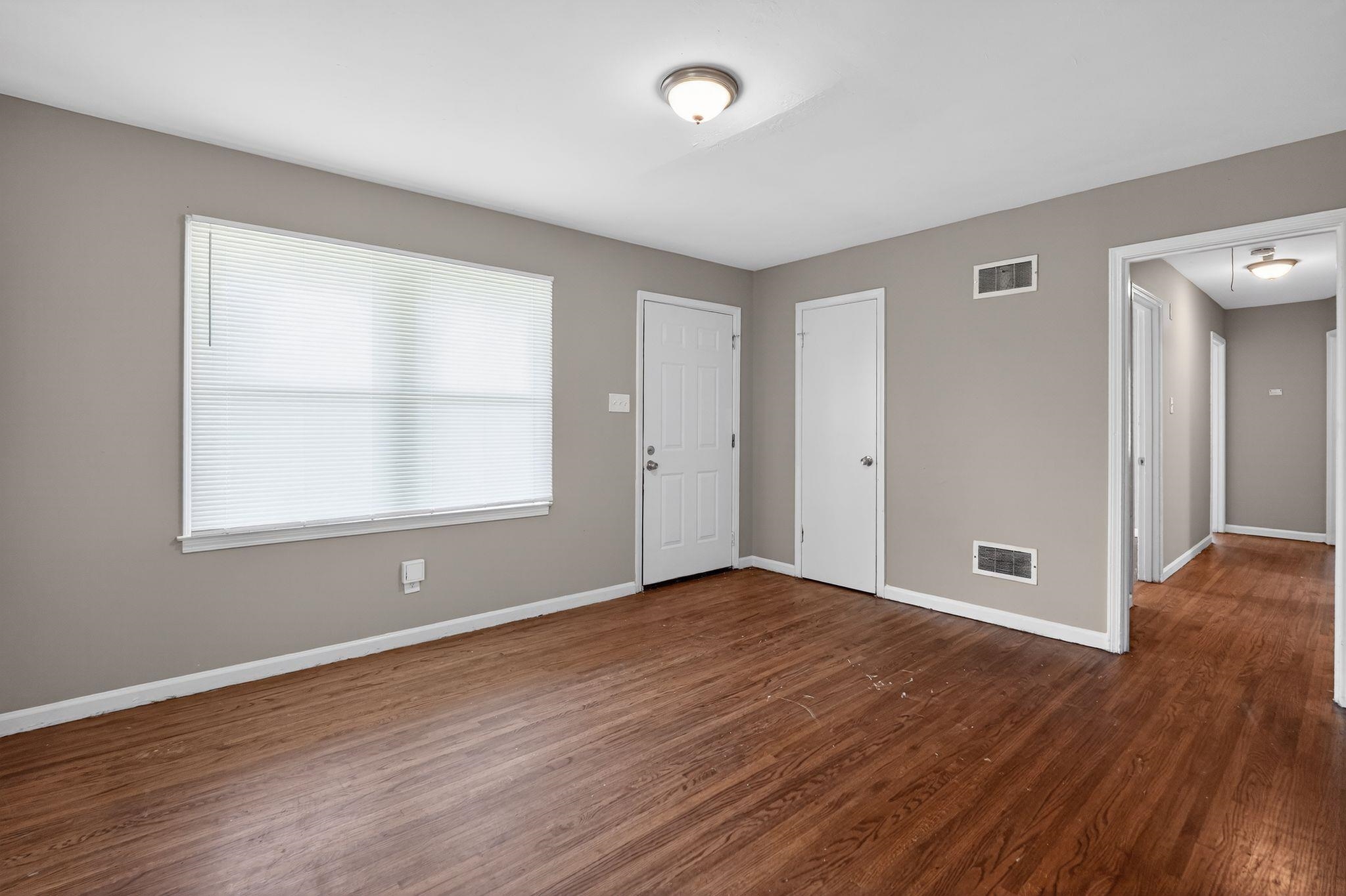 3220 Christine Road Memphis, TN 38118 - Photo 8 of 35 a view of an empty room with wooden floor and a window