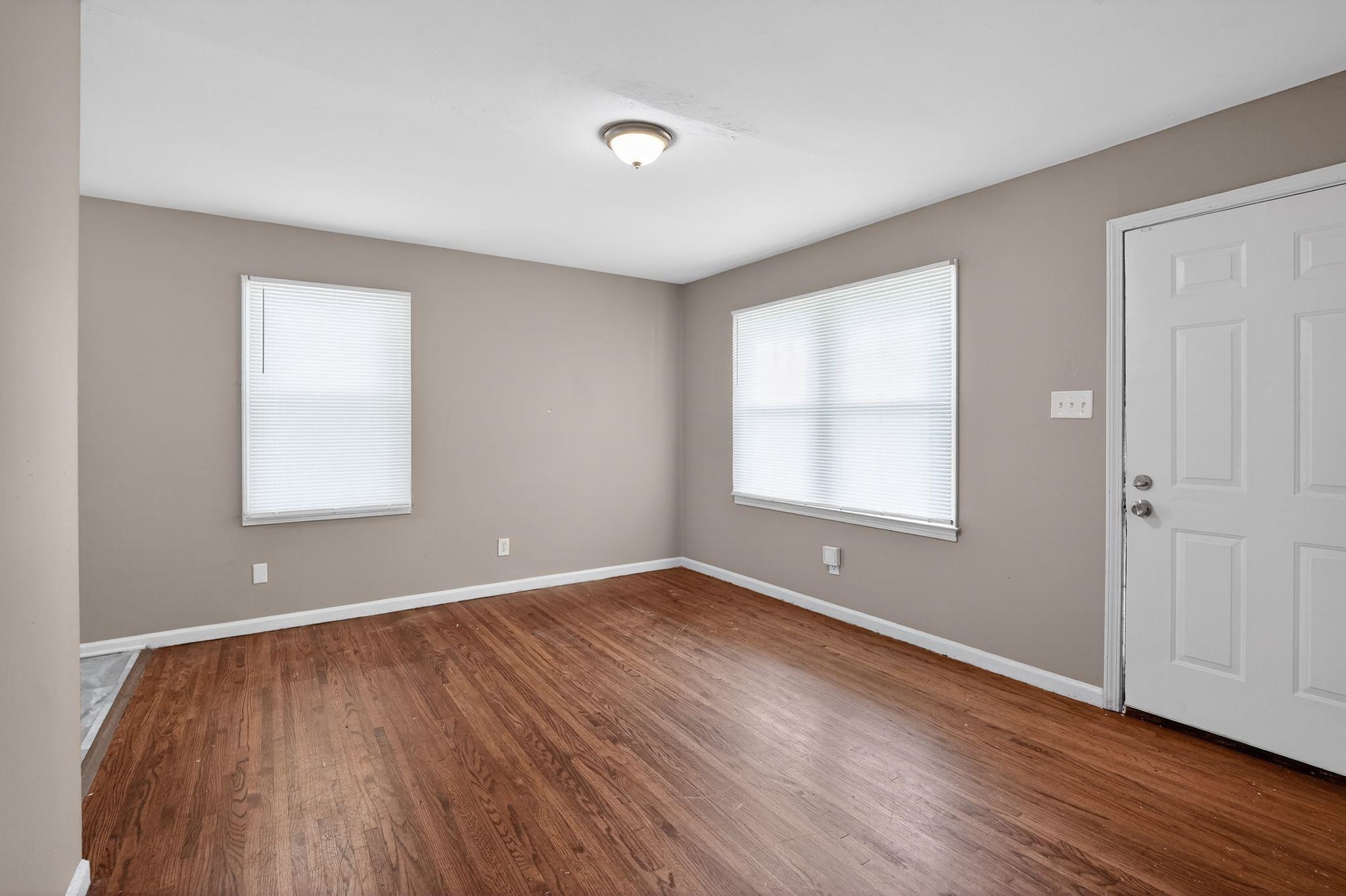3220 Christine Road Memphis, TN 38118 - Photo 9 of 35 an empty room with wooden floor and windows