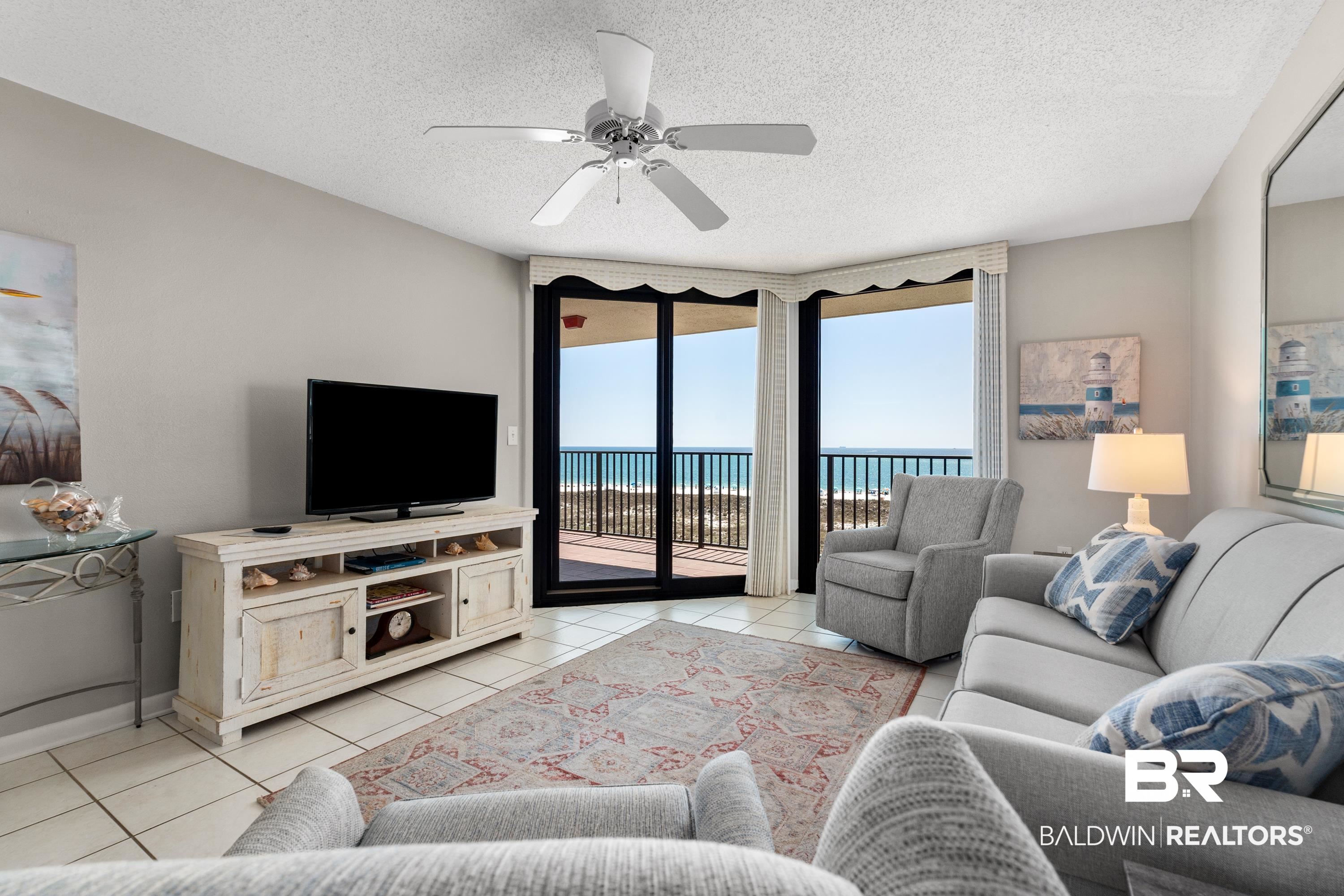 26802 Perdido Beach Boulevard, Unit 406 Orange Beach, AL 36561 - Photo 3 of 37 Living room with a ceiling fan, a textured ceiling, and light tile patterned floors