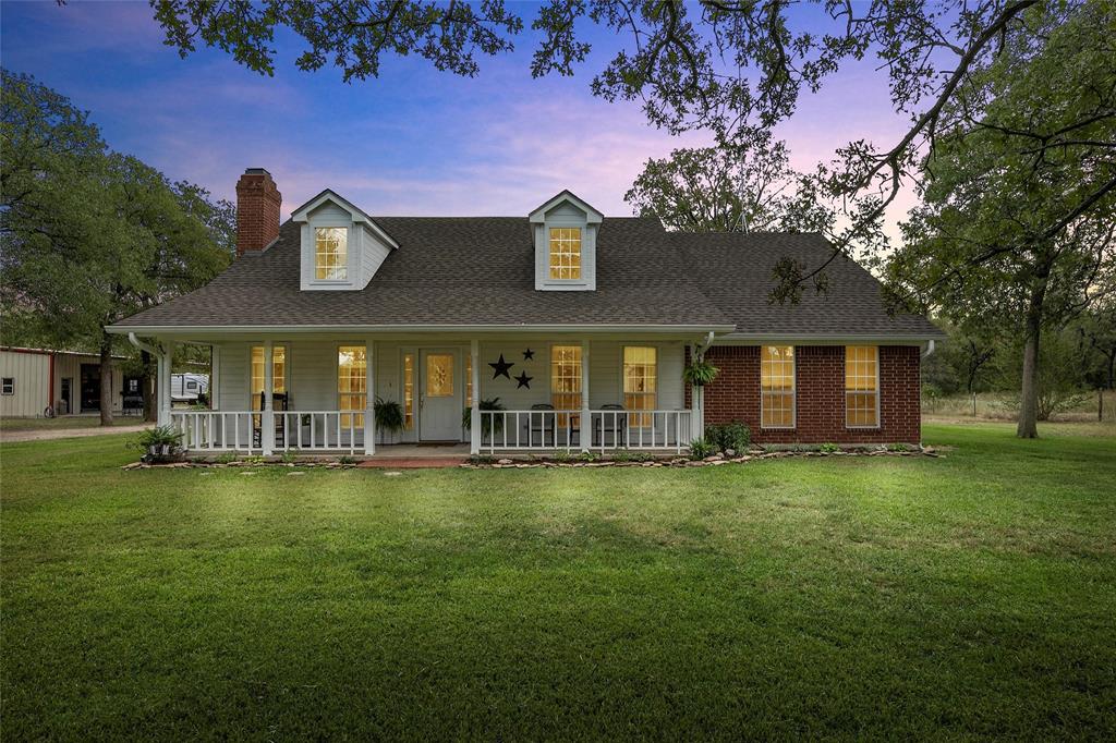 649 Raceway Road Axtell, TX 76624 - Photo 1 of 1 View of front of home with a chimney, covered porch, roof with shingles, and a yard