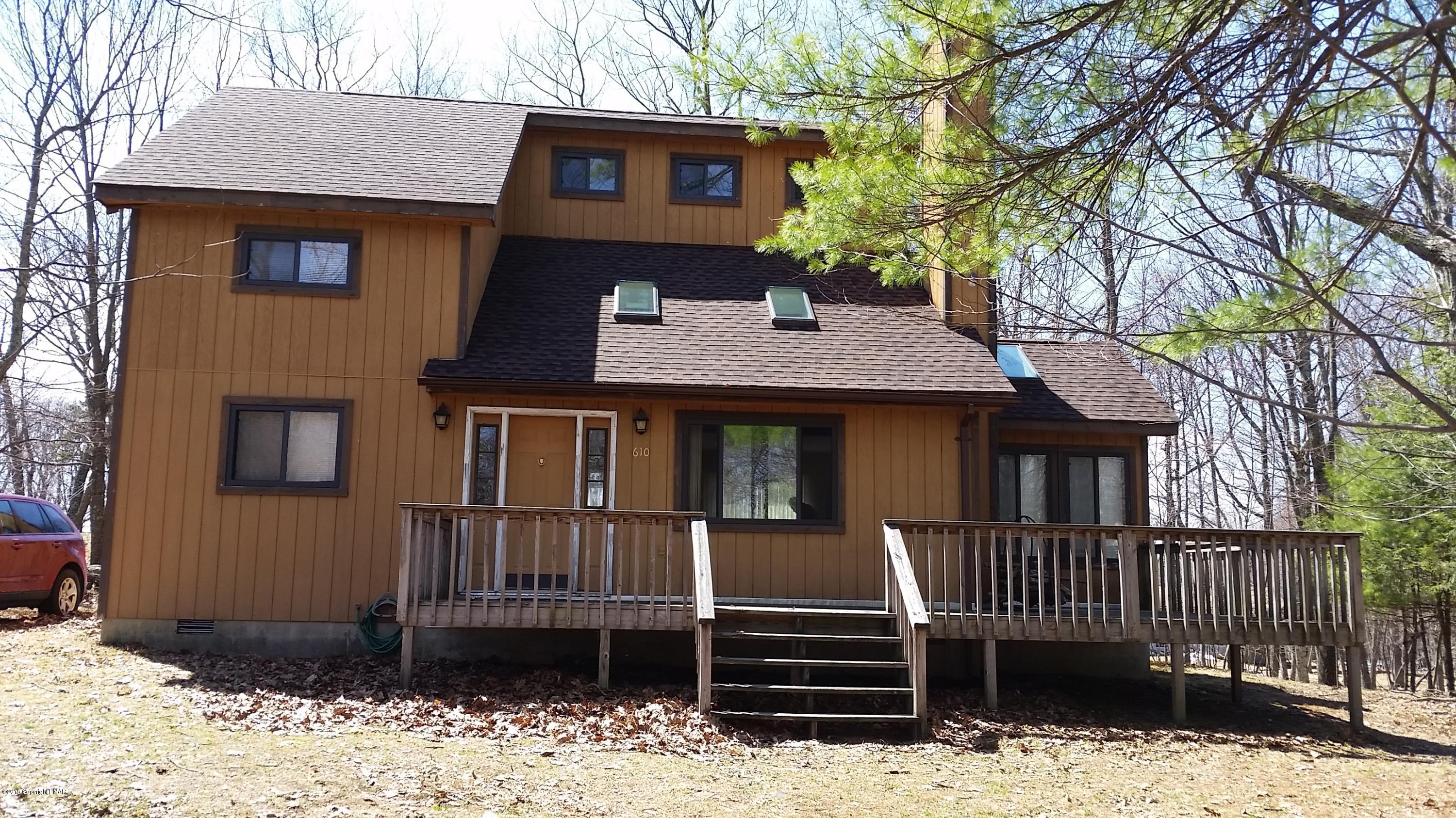 195 Gold Finch Road Bushkill, PA 18324 - Photo 1 of 14 a front view of a house with a yard covered with snow