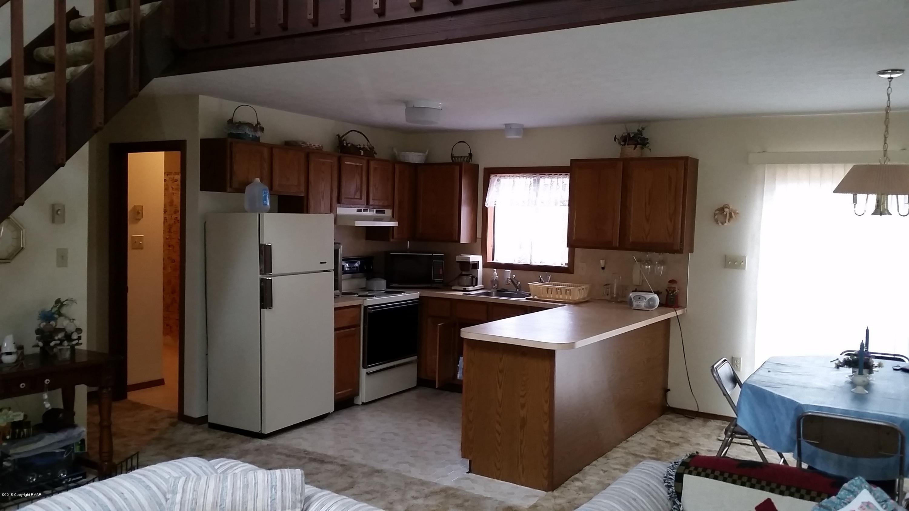 195 Gold Finch Road Bushkill, PA 18324 - Photo 3 of 14 a kitchen with refrigerator and cabinets