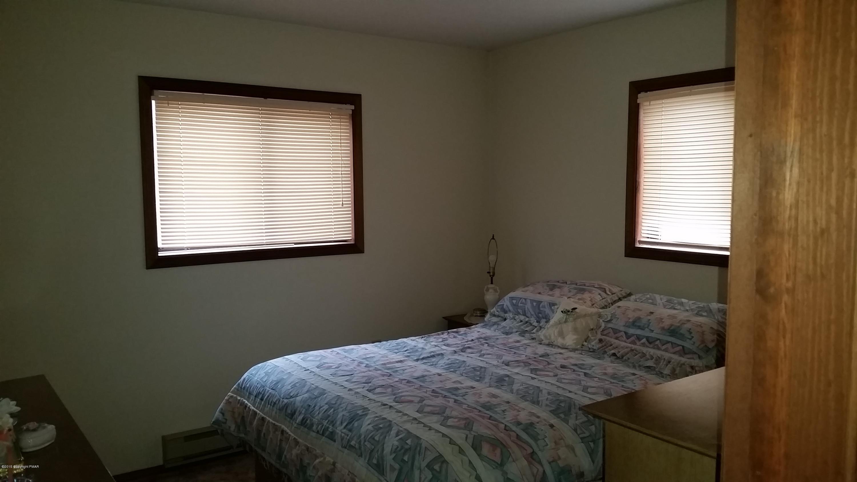 195 Gold Finch Road Bushkill, PA 18324 - Photo 5 of 14 a bedroom with a bed window and a window